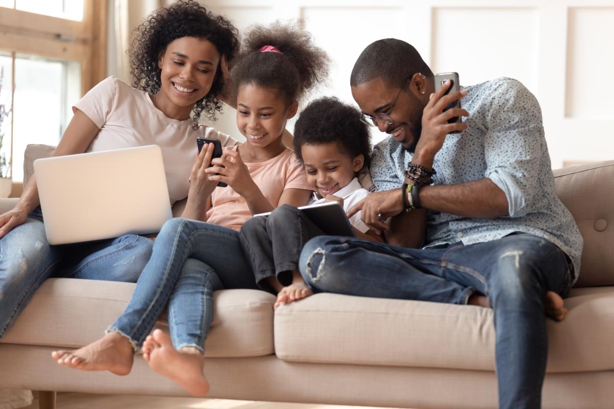 Family of parents and children using devices
